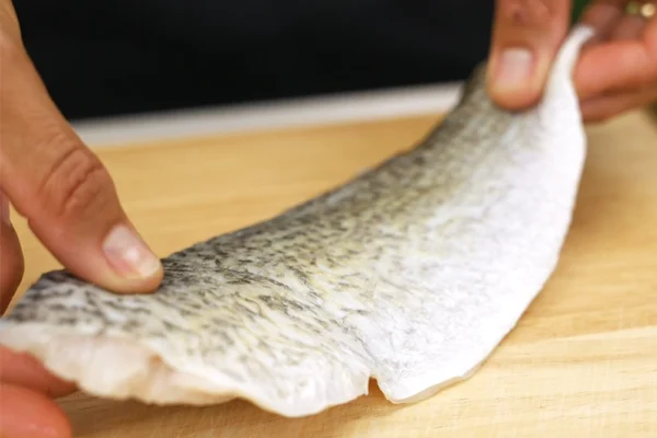 Barramundi-Fillets-Netuno A barramundi fillet is placed on a cutting board