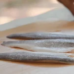 Branzino fillets on a cutting board to be seasoned