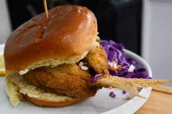 Butterflied-Yellowtail-Fillet-Minuta-Sandwich a plated yellowtail snapper "pan con minuta" sandwich