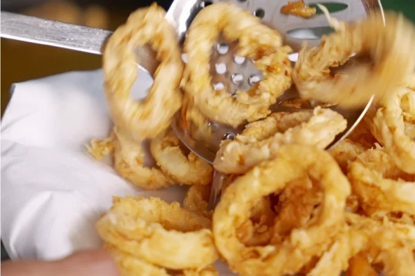 Frozen-Calamari-Rings-Cooked Fried calamari rings being removed from the oil