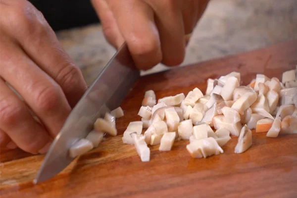 Frozen-Conch-Meat-Cooking A chef chops raw conch meat