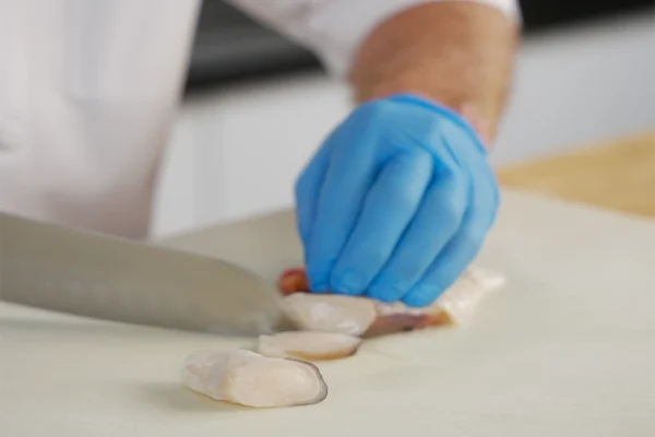 Frozen-Conch-Meat-Netuno A chef slices pieces of conch meat