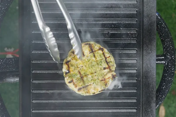 Frozen-Shrimp-Burger-Grilled A shrimp burger patty is cooking on a grill