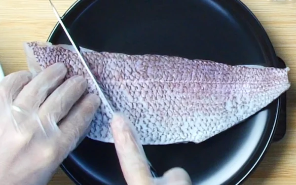 King-Snapper-Fillet A chef prepares to score a King Snapper Fillet