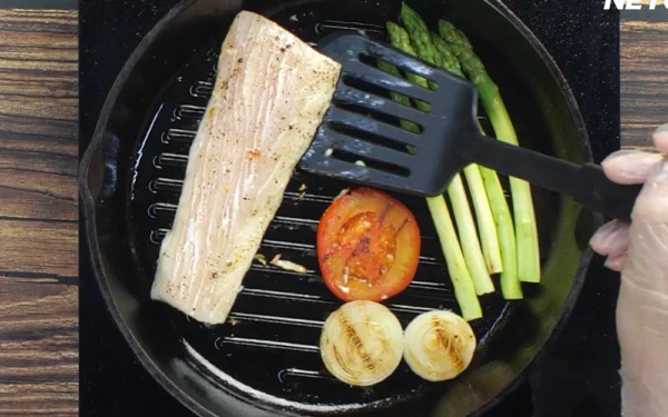 Mahi-Fillet Mahi Mahi in a grill pan cooking with vegetables