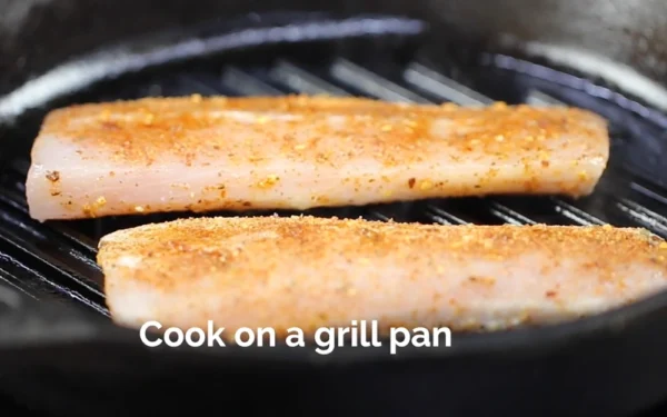 Mahi-Fillet-Portion Seasoned Mahi Mahi on a grill pan cooking