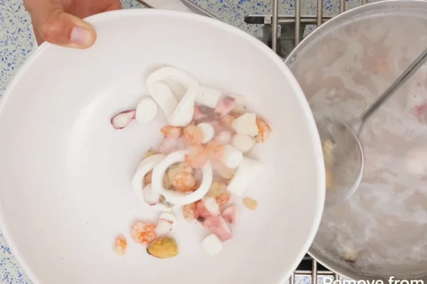 Seafood-Mix-Frozen Seafood Medley is blanched and removed from the water