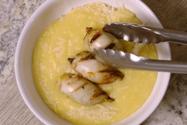 Squid-Tubes-Polenta Grilled and Stuffed Calamari tubes are plated over creamy polenta