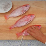 Chef prepares to score a whole vermillion beeliner snapper