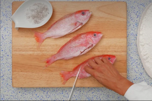 Whole-Vermillion-Snapper Chef prepares to score a whole vermillion beeliner snapper